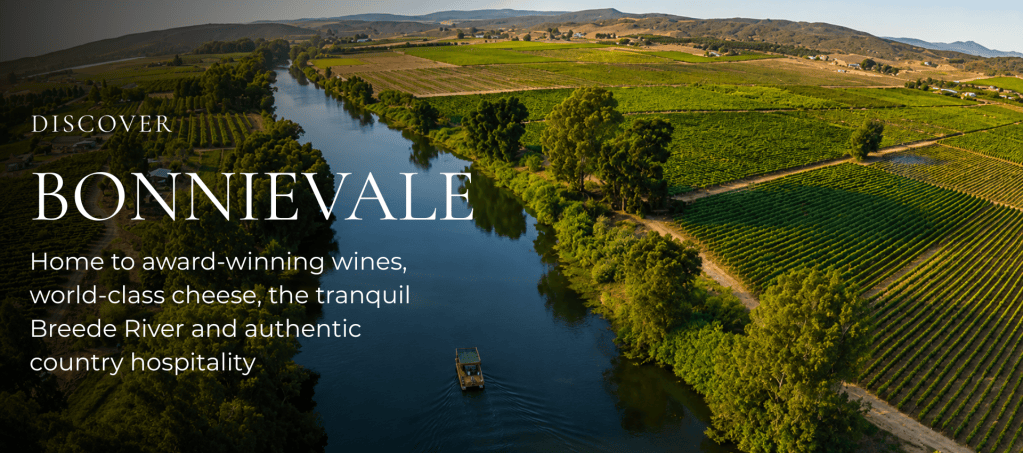 Aerial view of Bonnievale showcasing lush vineyards and the Breede River, highlighting the region's award-winning wines and country hospitality.
